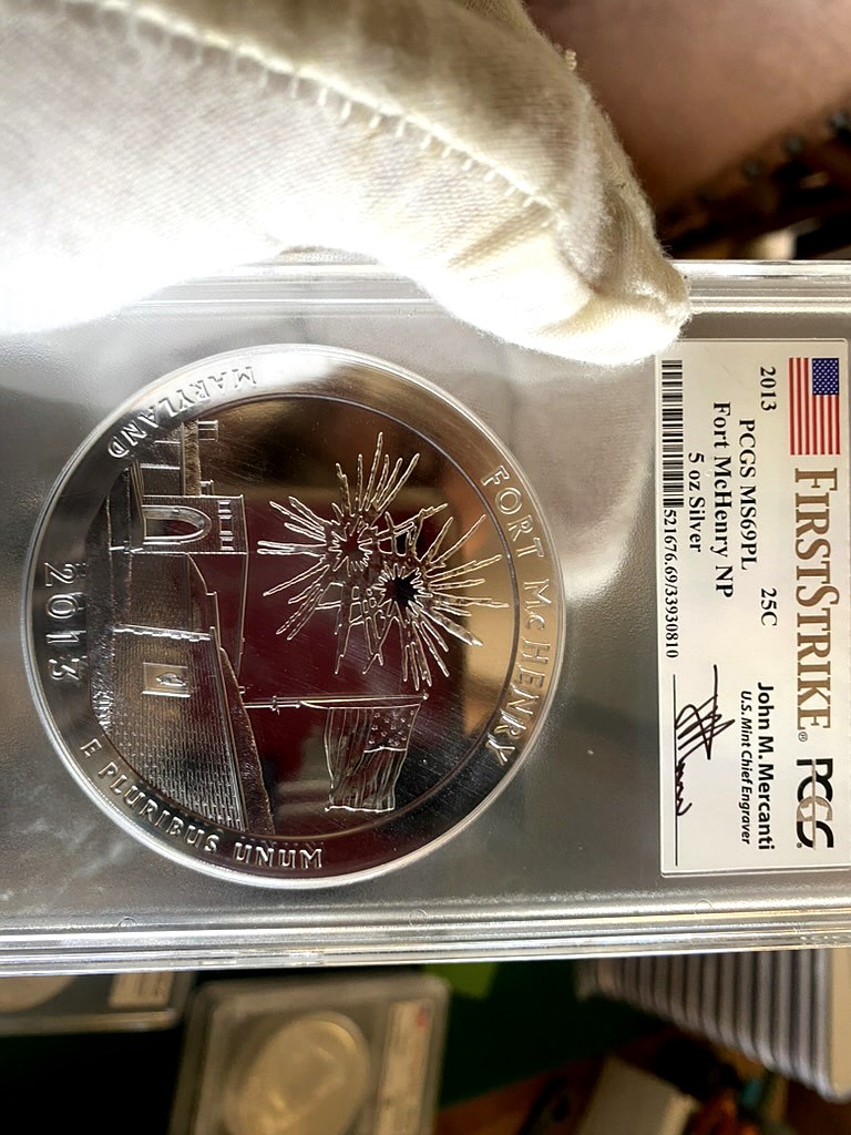 2013 Fort McHenry 5 oz Silver ATB — PCGS MS69PL First Strike, Mercanti Signed — obverse shown in hand, photographed in hand at Capstone Metals.