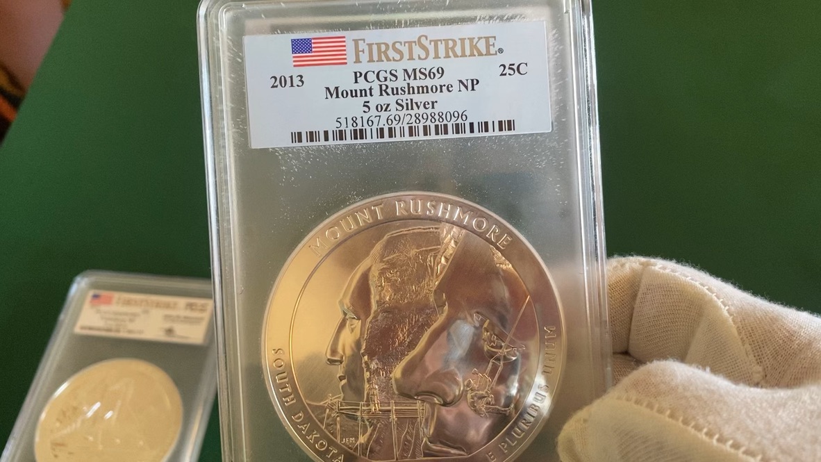 2013 Mount Rushmore 5 oz Silver America the Beautiful — PCGS MS69 First Strike — obverse shown in hand, photographed in hand at Capstone Metals.