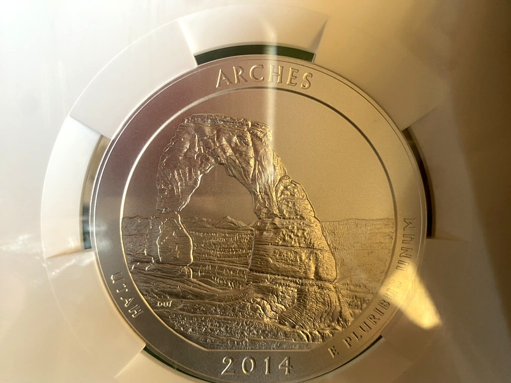 2014 Arches 5 oz Silver ATB — NGC Certified, Delicate Arch — obverse shown in hand, photographed in hand at Capstone Metals.