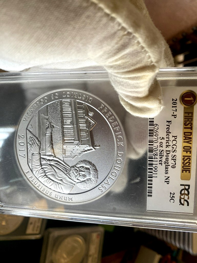 2017-P Frederick Douglass 5 oz Silver ATB — PCGS SP70 First Day of Issue — obverse shown in hand, photographed in hand at Capstone Metals.