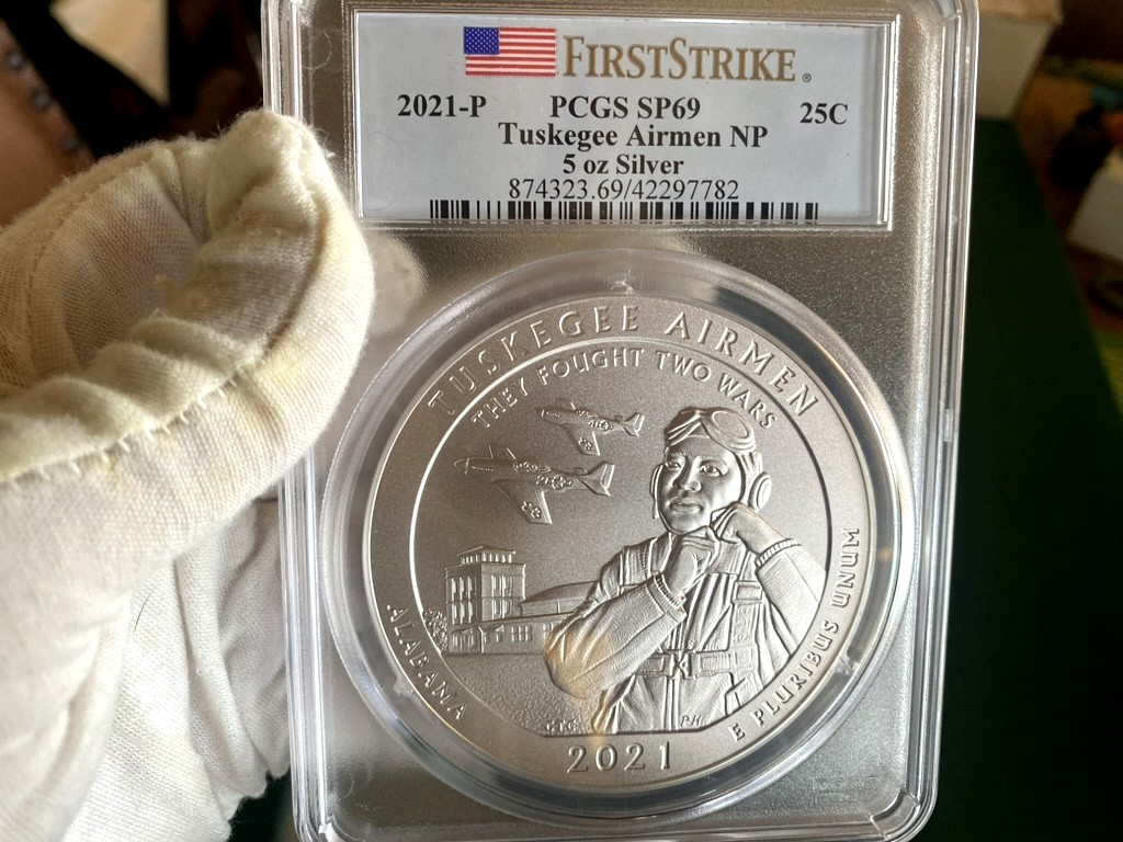 2021-P Tuskegee Airmen 5 oz Silver ATB — PCGS SP69 First Strike — obverse shown in hand, photographed in hand at Capstone Metals.