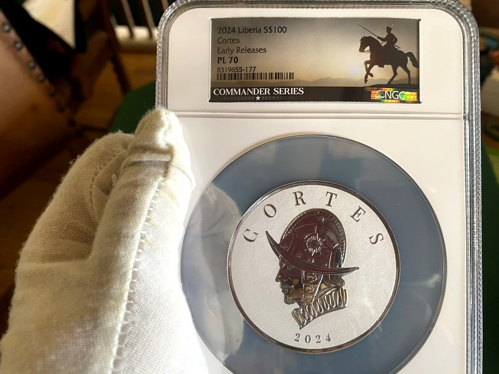 2024 Liberia $100 Cortes 5 oz Silver — NGC PL70 Early Releases, Commander Series — obverse shown in hand, photographed in hand at Capstone Metals.